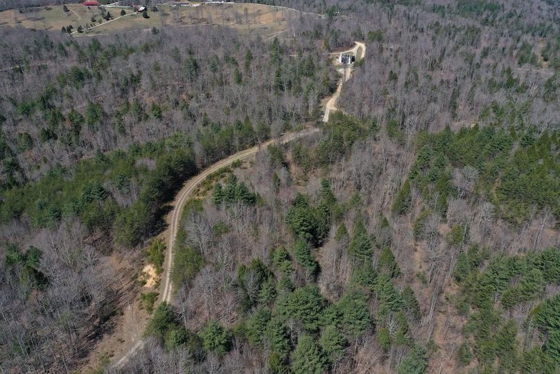 033 aerial drone shot looking at the property entrance and private drive