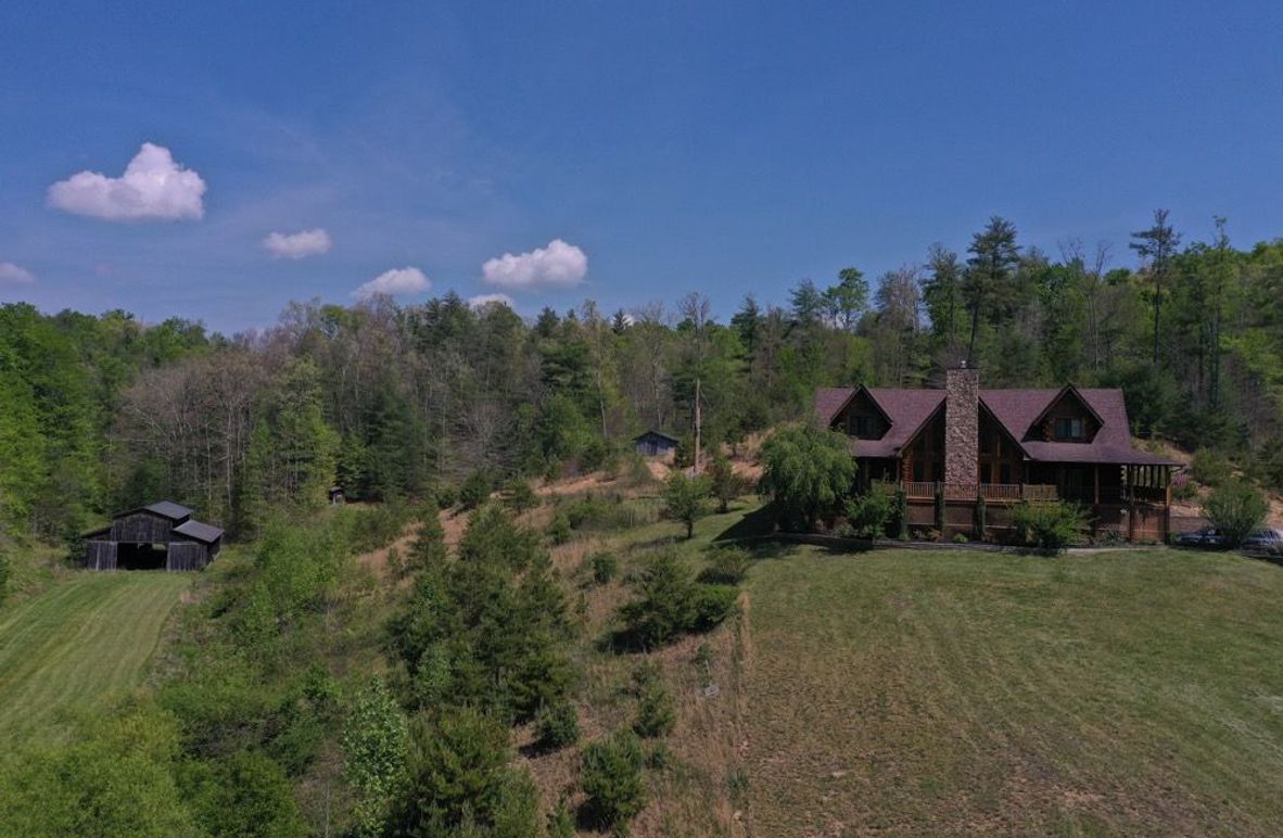001 low elevation front view of the log home and barn