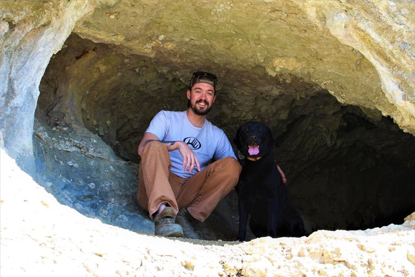 006 whitetail properties agent, cory meade and field assistant aspen in a small cave