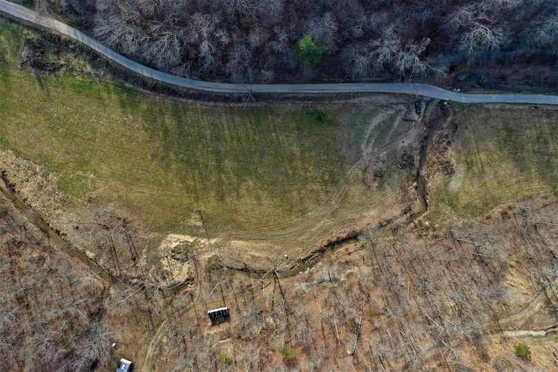 014 aerial drone shot looking down on the fields, creek and one of 3 entrances off the main road