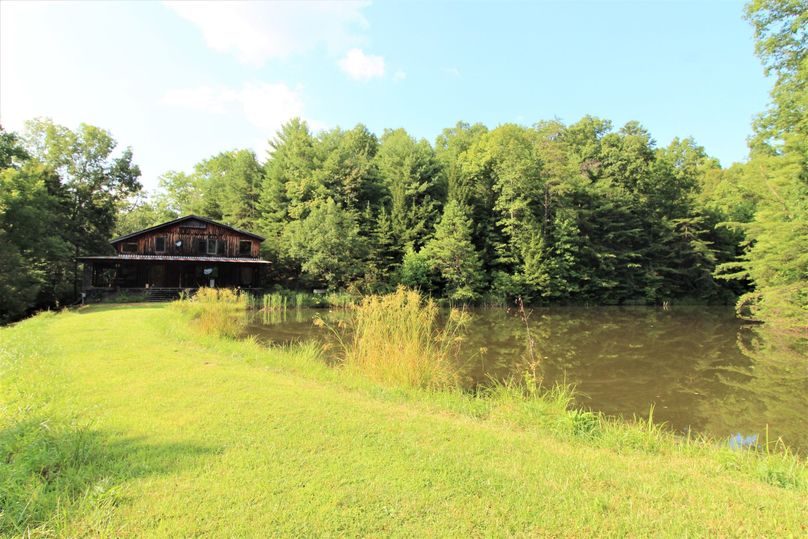 015 landscape photo of the cabin and pond from the dam