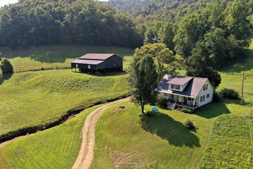 001 low elevation drone shot of the home and barn
