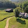 001 low elevation drone shot of the home and barn