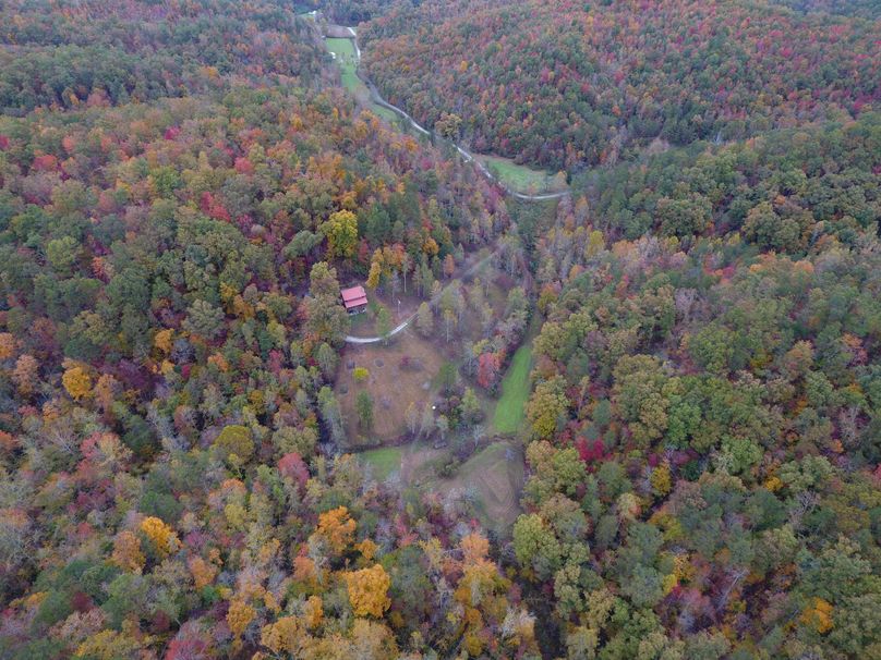 026i high elevation drone shot of the cabin and fall colors