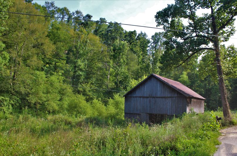 Gorgeous summer photo of the barn along the pavement road