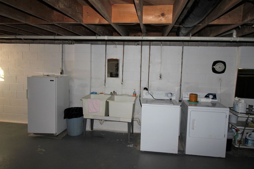 048 view of the washer, dryer and sink in the basement