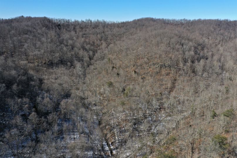 042 aerial drone shot from the north middle of the property looking up the valley to the north
