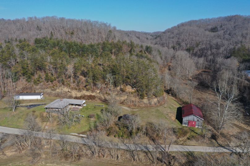 001 low elevation aerial drone shot of the home and structures from the south boundary looking north