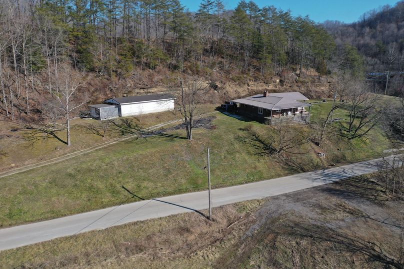 022 low elevation drone shot from the west edge looking in at the home and shop