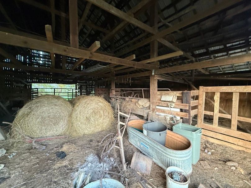 014 Spacious barn interior provides practical storage for hay, equipment, and livestock