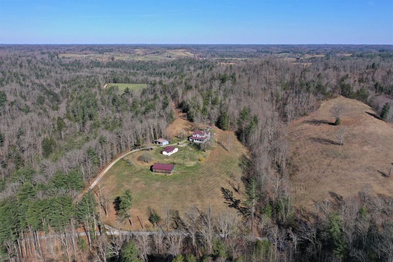 009 mid elevation drone shot from the southeast looking over the home, barn, workshop and guest house