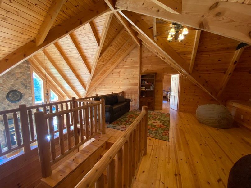 049 the stairs arriving up to the second floor showing the high ceilings and large wood beams