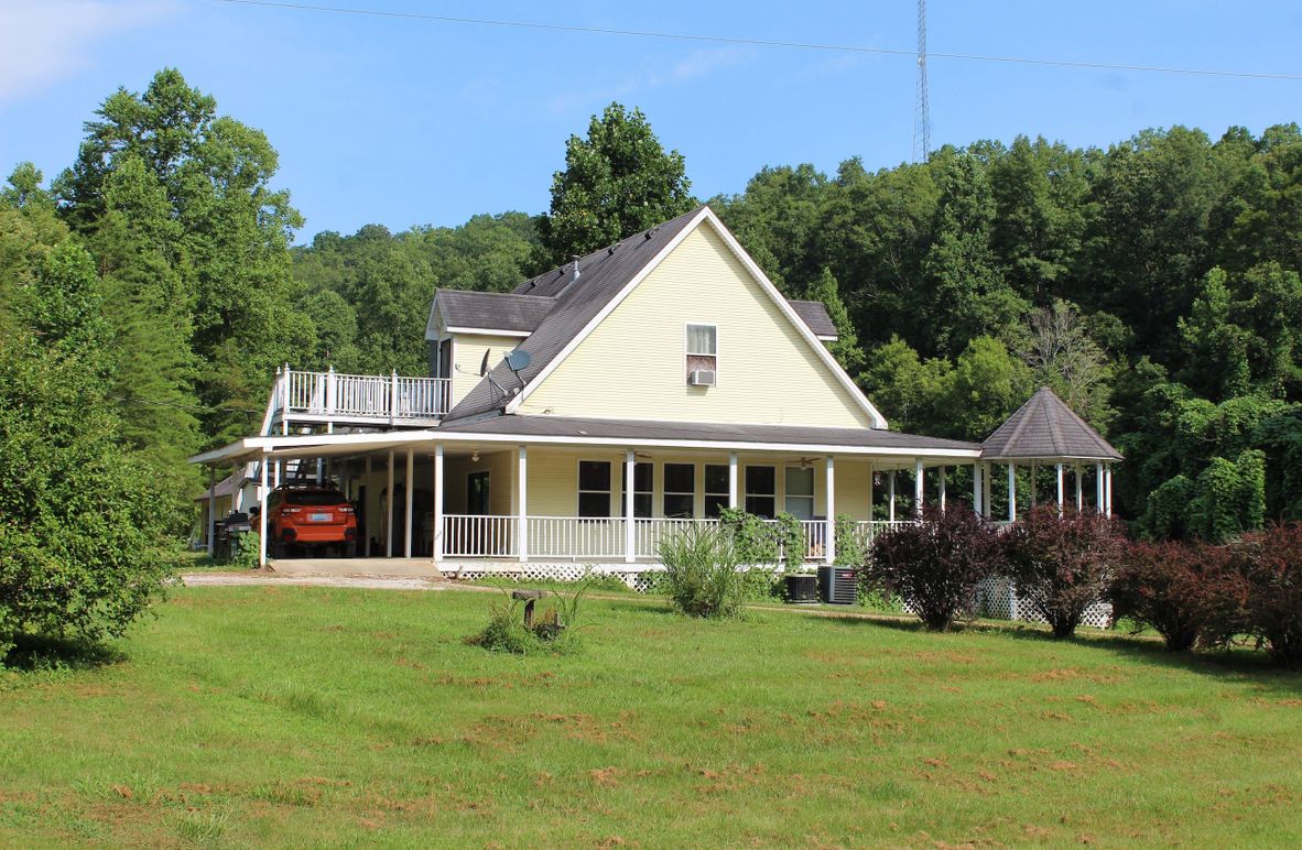 001 beautiful east view of the main home as you pull up the driveway