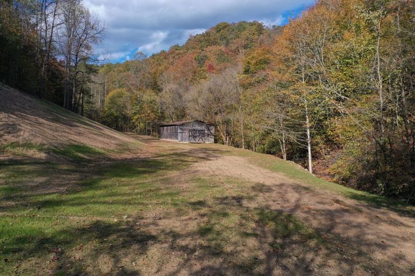 018 low elevation drone shot of the building lot and barn at the front of the property
