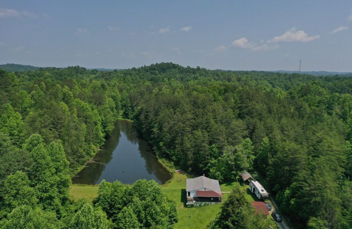 001 aerial drone shot of the home and pond