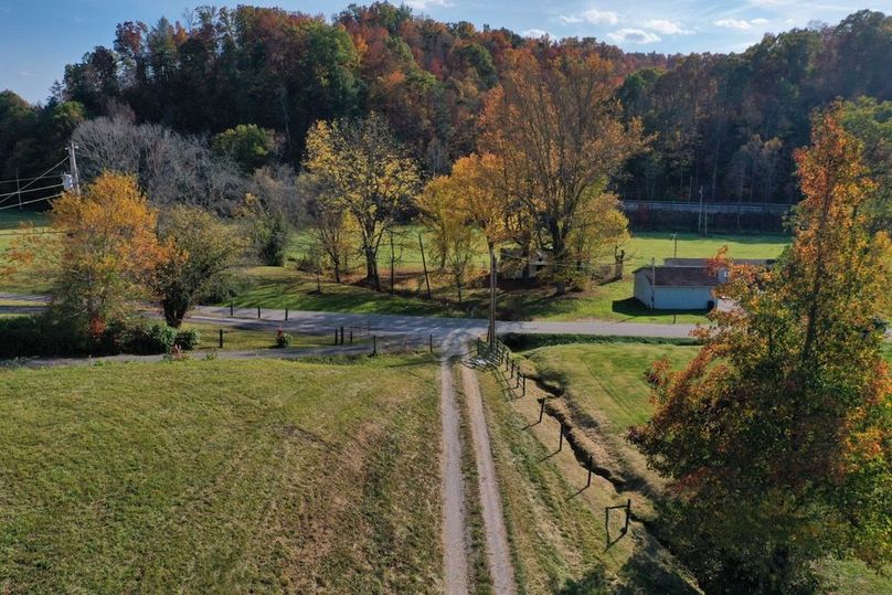 023 low elevation drone shot in the south area of the property from over the house looking towards the entrance-2