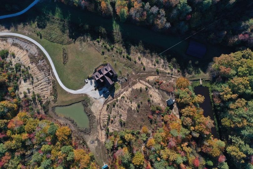 027 aerial drone shot looking down on the home and pond