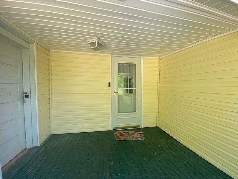 050 view of covered back porch area that enters into kitchen or laundry_mechanical add on room to the left copy