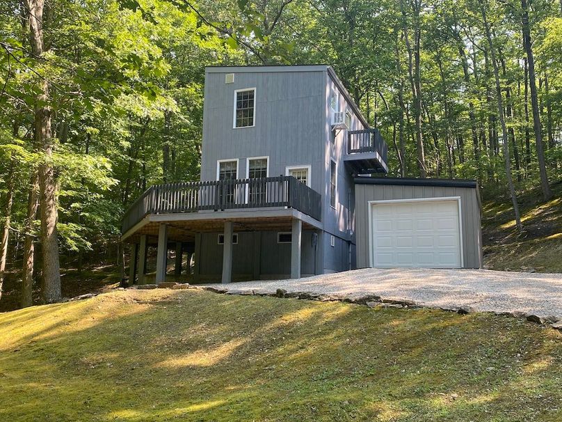 024 view of the home from the front south side along the woods copy