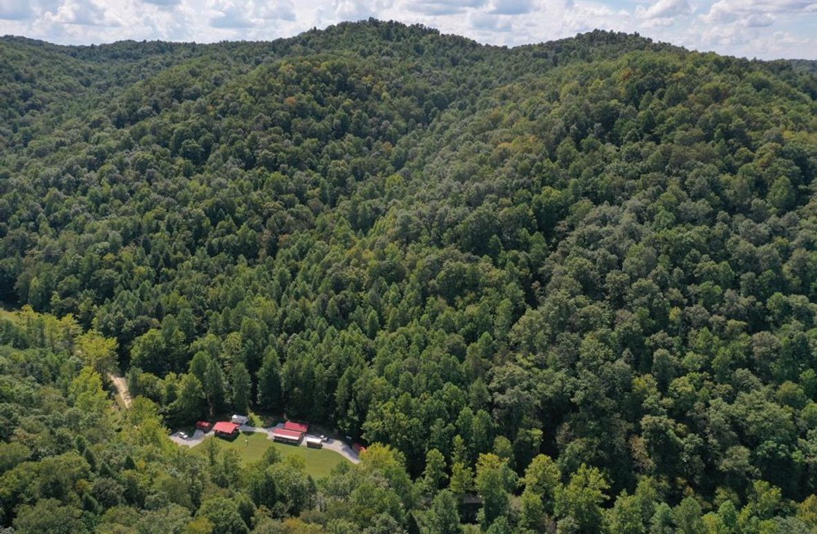 003 an aerial drone shot of the gathering location and the beautiful mountains in the backdrop