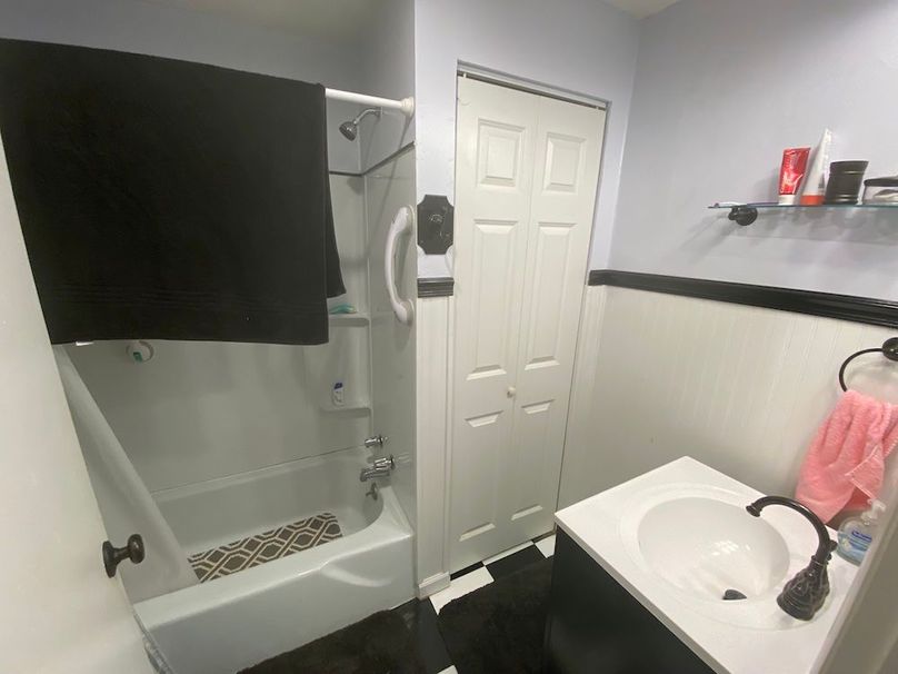 035 the bathroom located near the back of the home copy