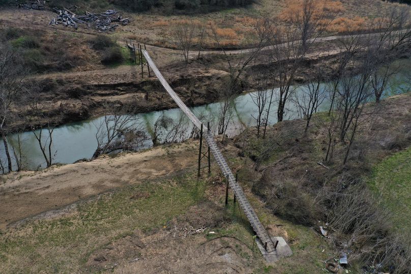 003 the swinging walk bridge leading on to the property