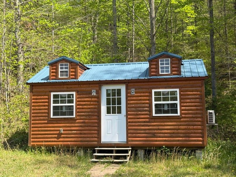 074 the small amish style cabin sitting at the back of the left pond