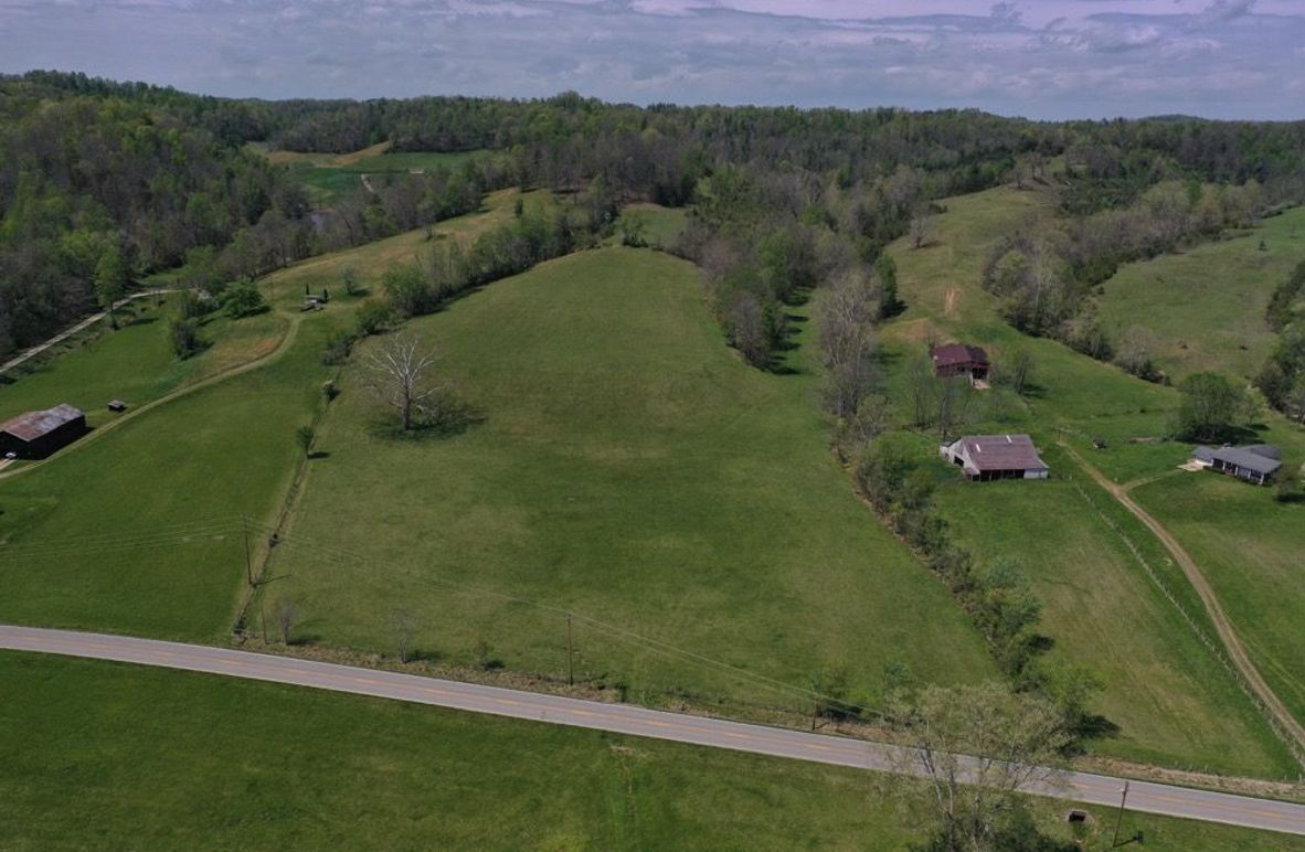 001 Stunning aerial perspective capturing the full character of the property. A gently rolling pasture, scenic surroundings, and excellent accessibility