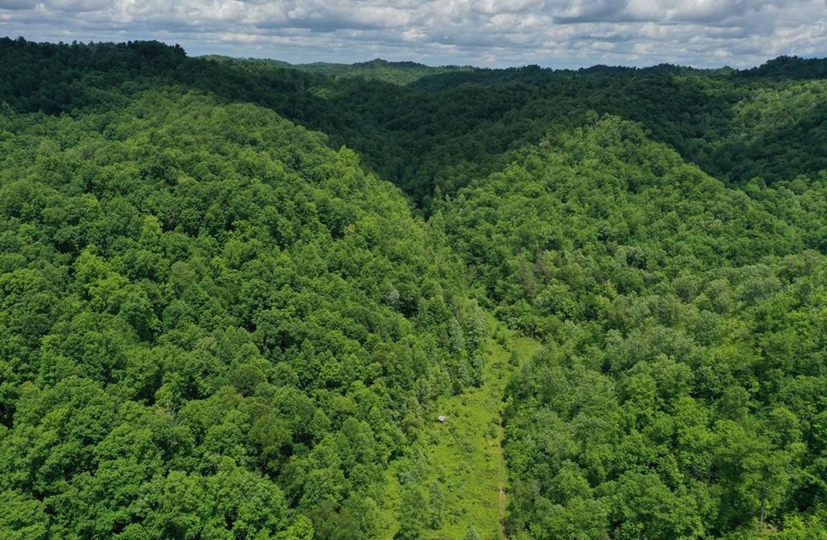 001 aerial drone shot from the south edge of the property looking north up the valley