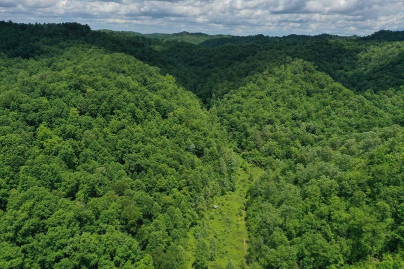 001 aerial drone shot from the south edge of the property looking north up the valley
