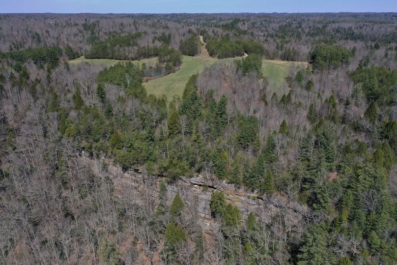 006 great aerial overview of cliff lines, fields, and road access to the north