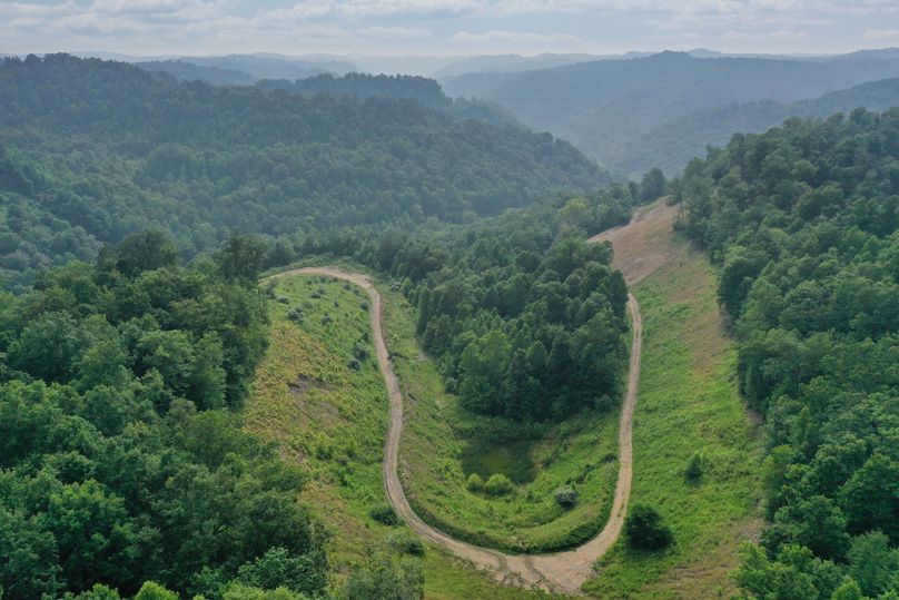 002 awesome mid elevation drone shot from the northeast area of the property looking west down the valley toward Lucky Fork