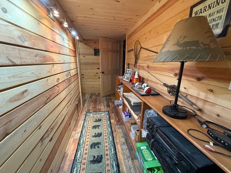 057 hall way leading to the lower level bathroom and exit door to the pond