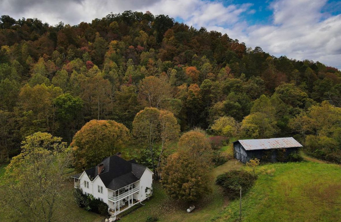 001 beautiful picturesque view of the home, barn, & timber