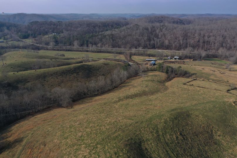 035 aerial drone shot from the middle of the property looking west toward the structures and west entrance