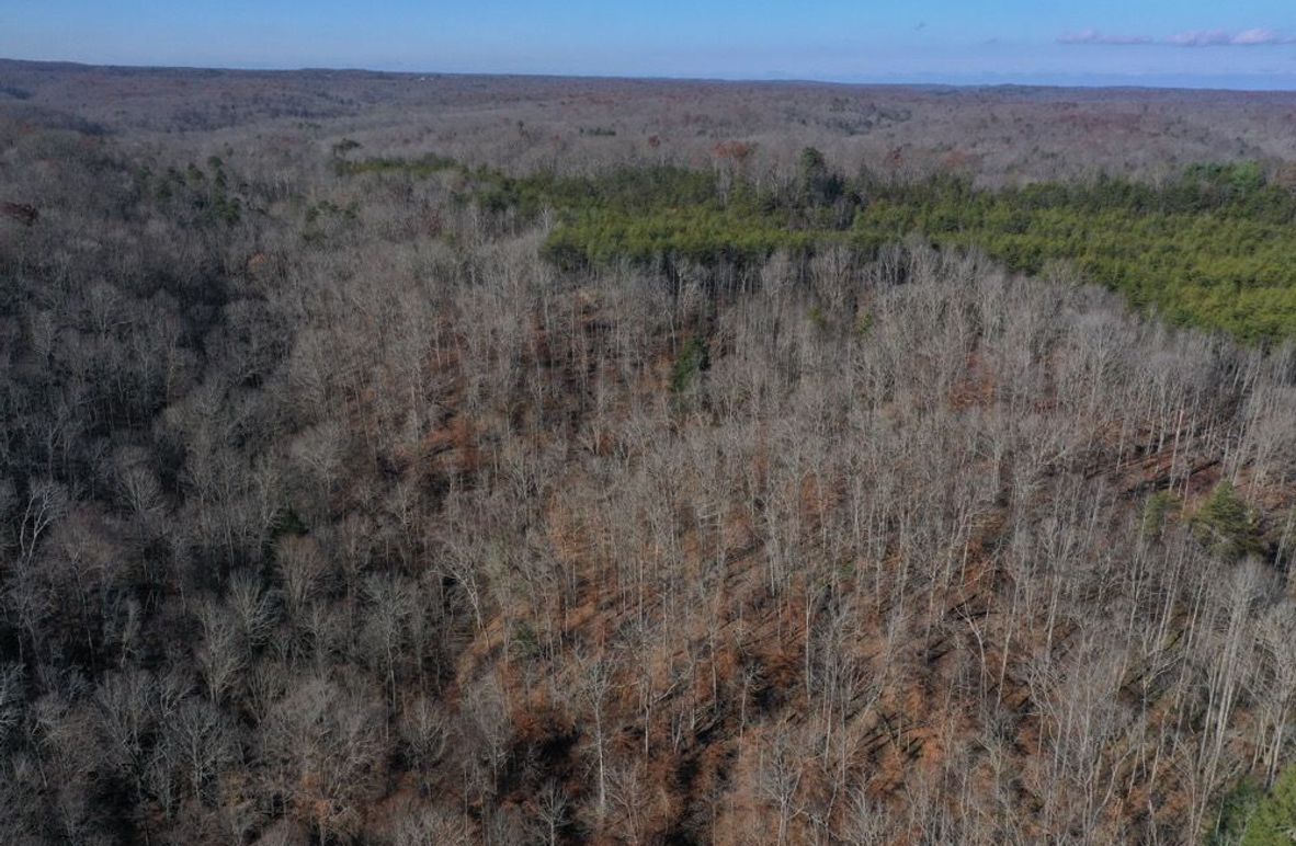 002 aerial drone shot from the southeast looking north over the property