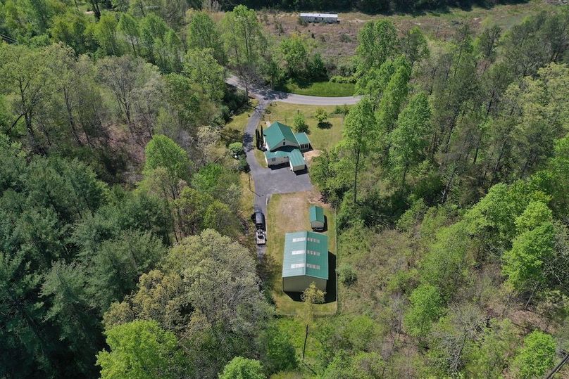 016 low elevation drone shot from behind the home and structures