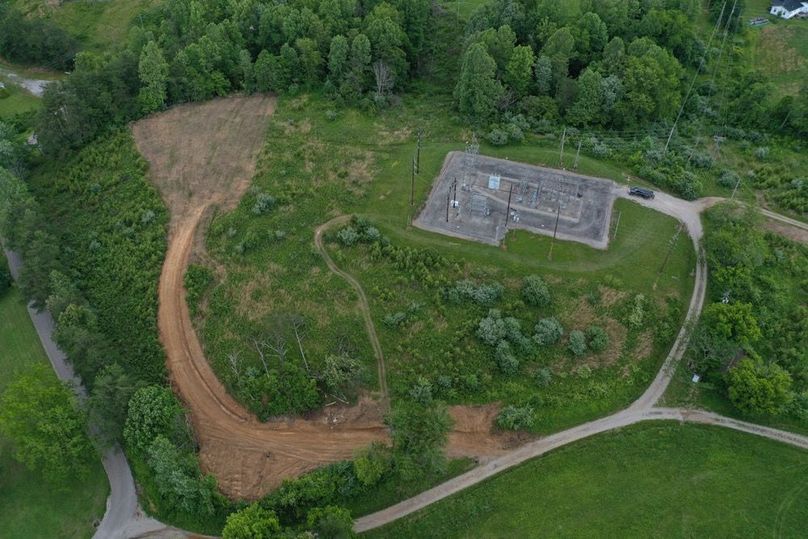 007 aerial drone shot from the west looking over the property