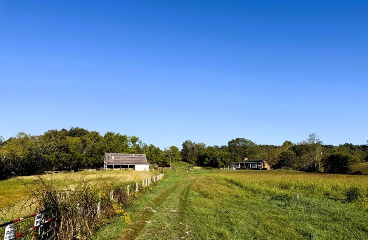 001 Gated entrance and long private drive create a welcoming sense of seclusion while leading into the heart of the property.