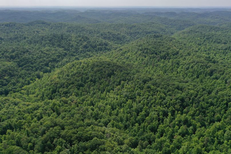 024 mid altitude aerial drone shot from the northwest corner of the property looking southeast down the valley