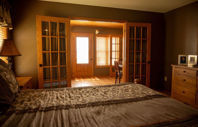 16 - Primary Suite Opens to Private Sun Room and Lakeside Deck