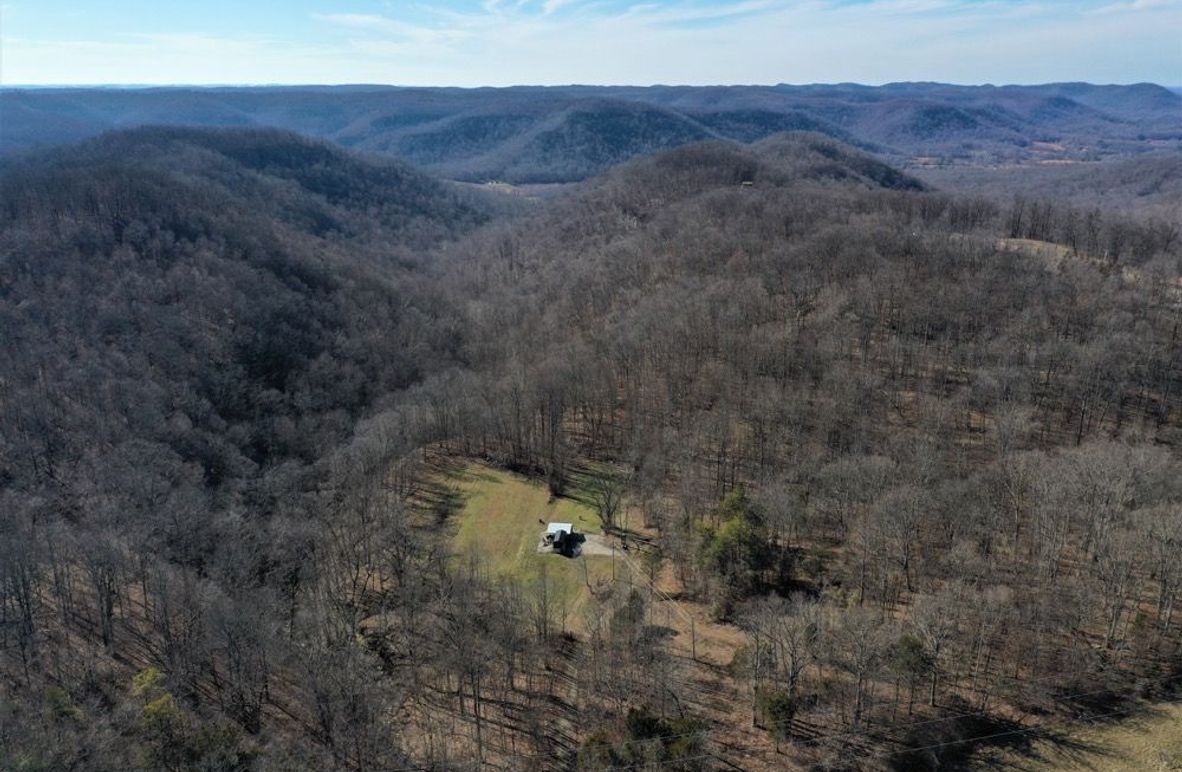 001 aerial drone shot from the east side of the property looking west down the valley